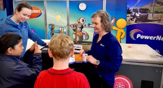 Science Roadshow team member Jade Imrie, left, and PowerNet Communications Coordinator Kathryn McCoy, right, chat with West Gore School pupils Amaya Duggaraju and Ayden Thompson at the Scien